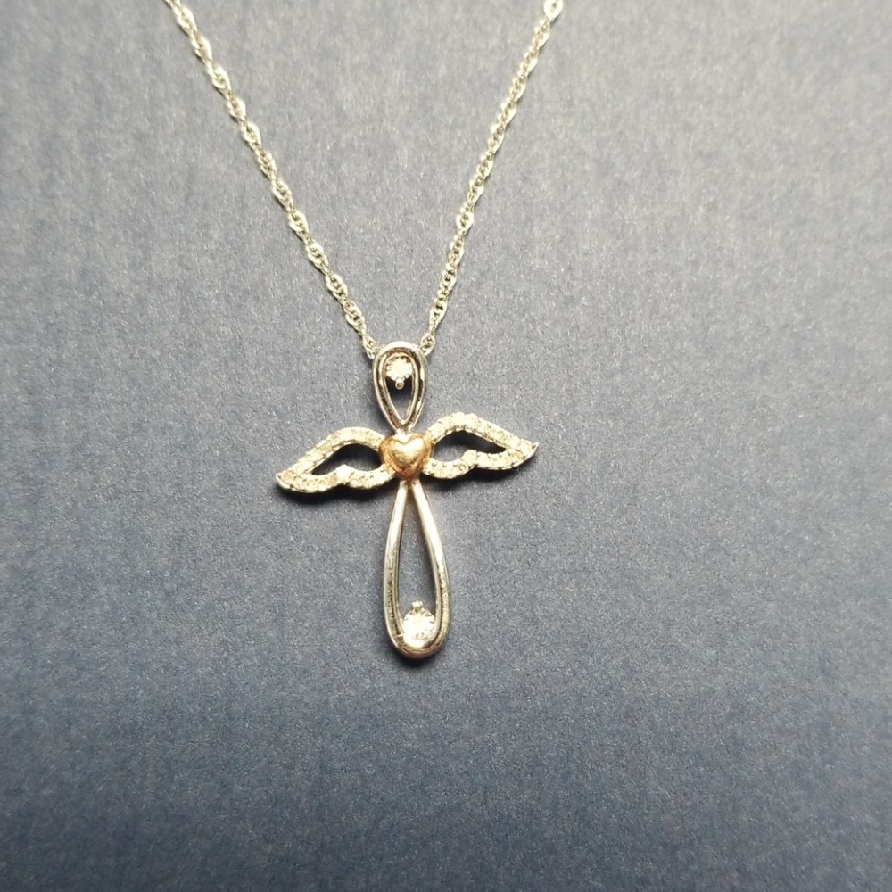 White gold angel necklace with diamond accents.